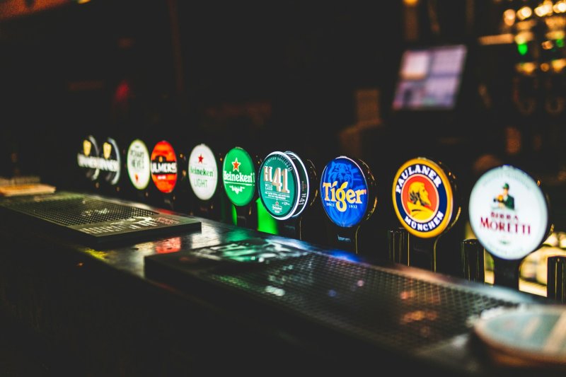 Beer taps by George Bakos beer taps lit up at night in bar