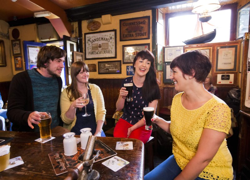 Friends at an Irish Bar - Copyright Failte Ireland people drinking guinness in irish pub